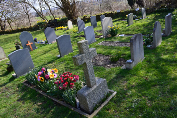 Well tendered graves in a rural English parish churchyard.